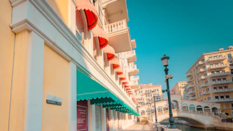 A charming European street with colorful buildings and cobblestone paths under a bright sky