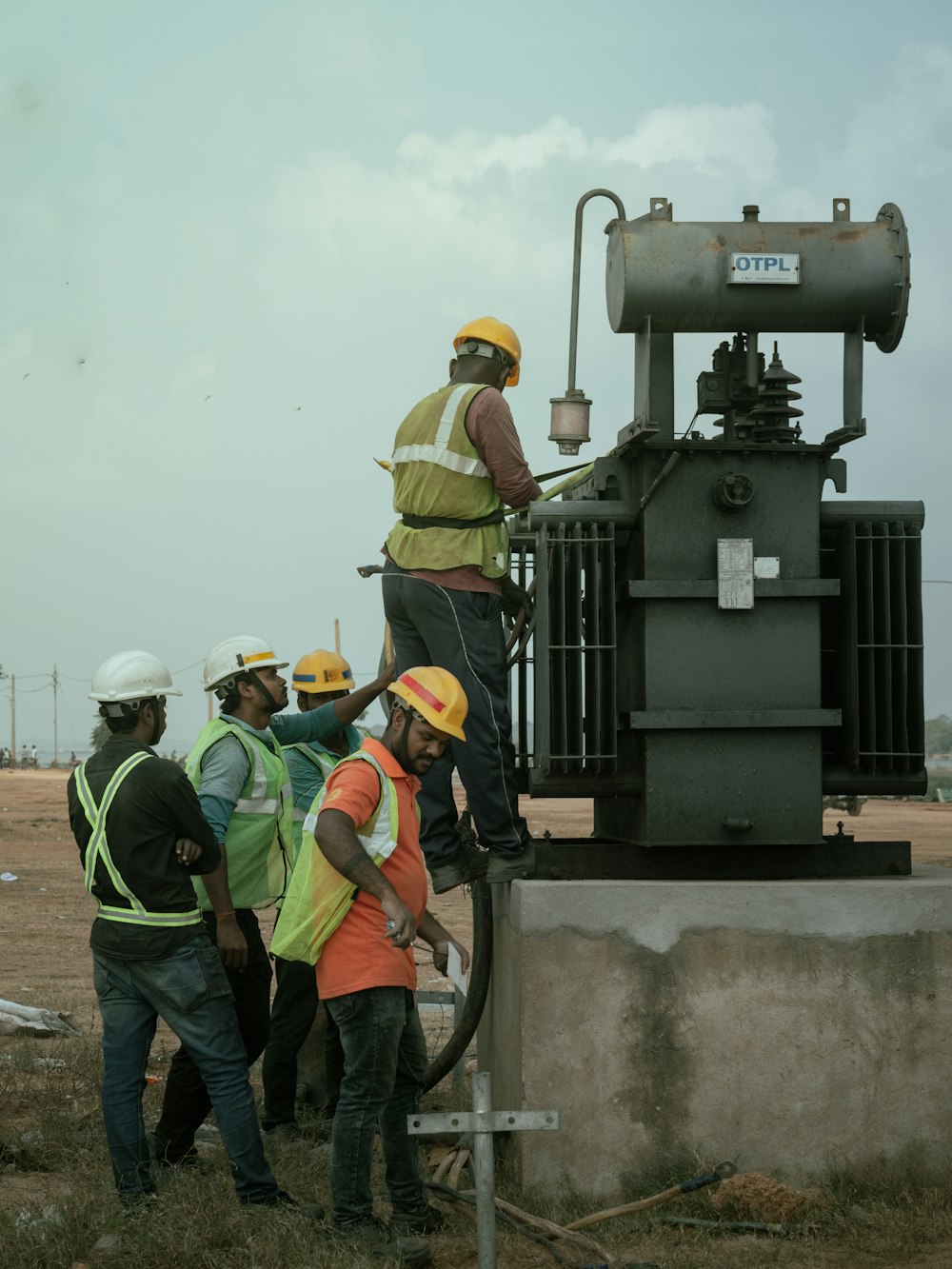 a group of men standing around a machine