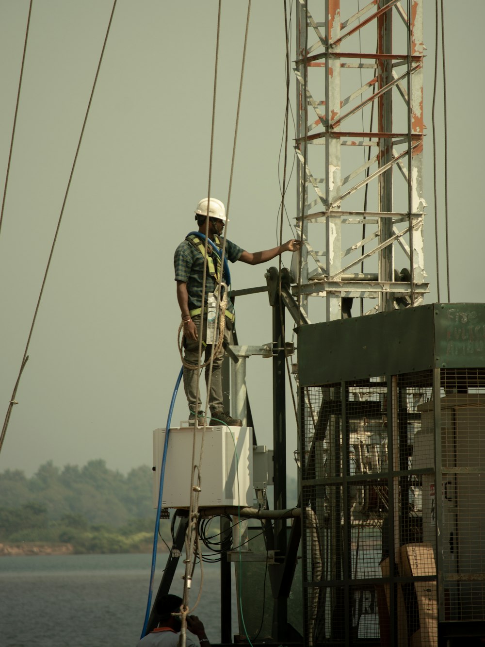 a man standing on top of a boat on top of a body of water