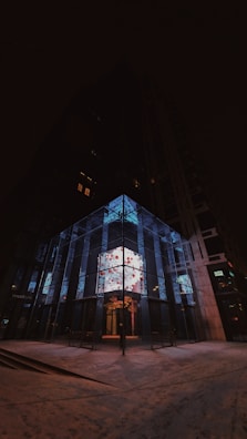 An outdoor LED display integrated seamlessly into urban architecture, glowing at sunset.