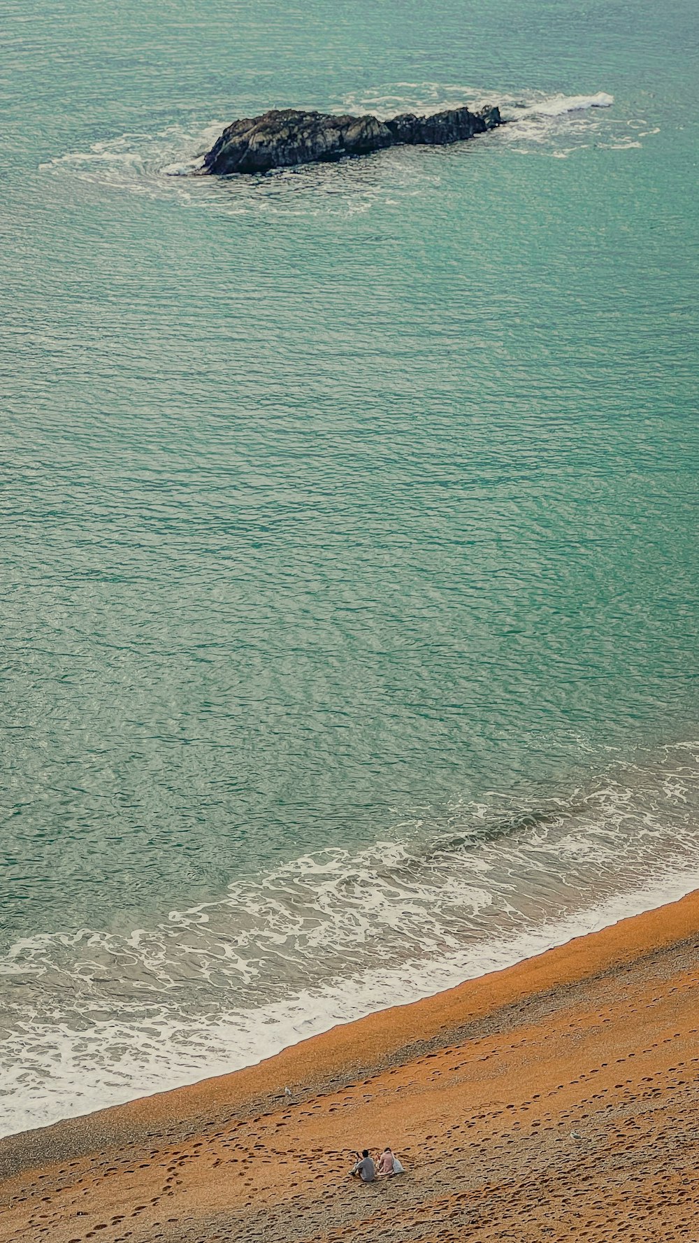 a person laying on a beach with a surfboard