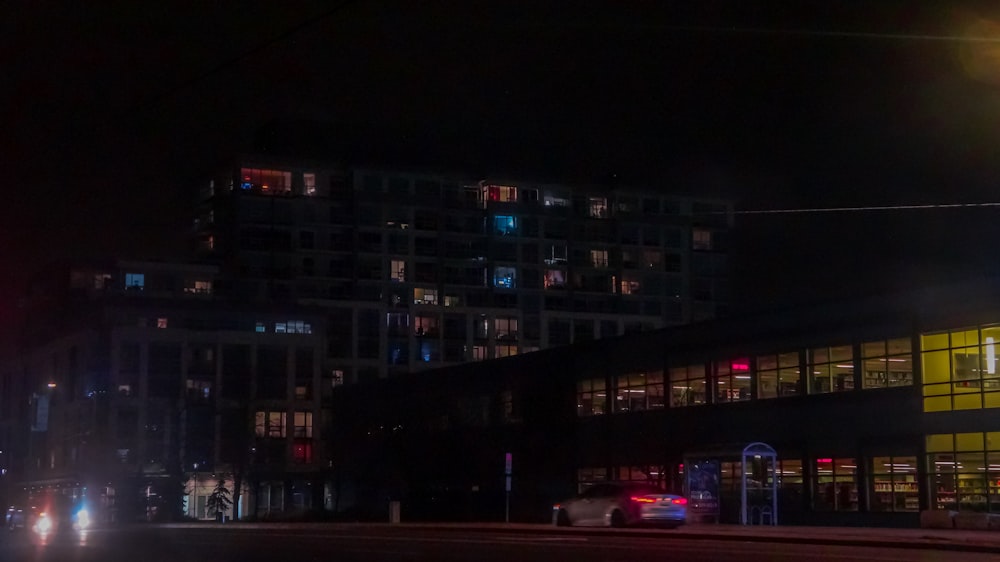 a car driving down a city street at night