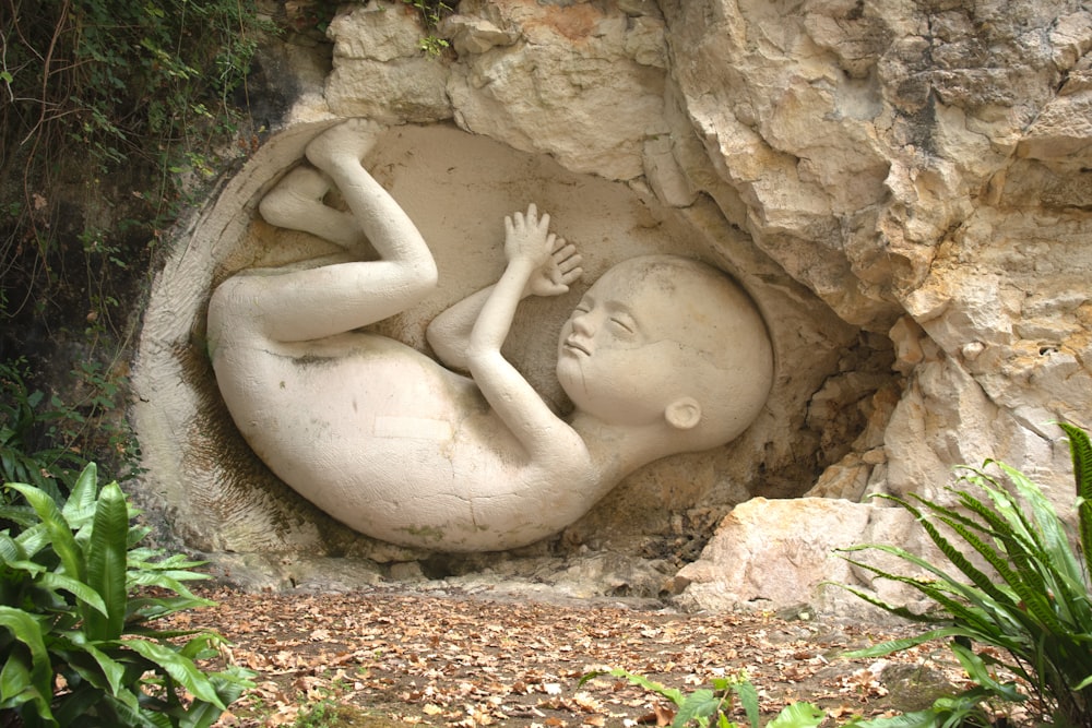 a statue of a baby in a cave