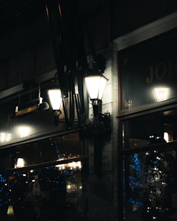 Cozy golden-lit mahala street at dusk with warm glowing lamps and intricate black and gold decorations.