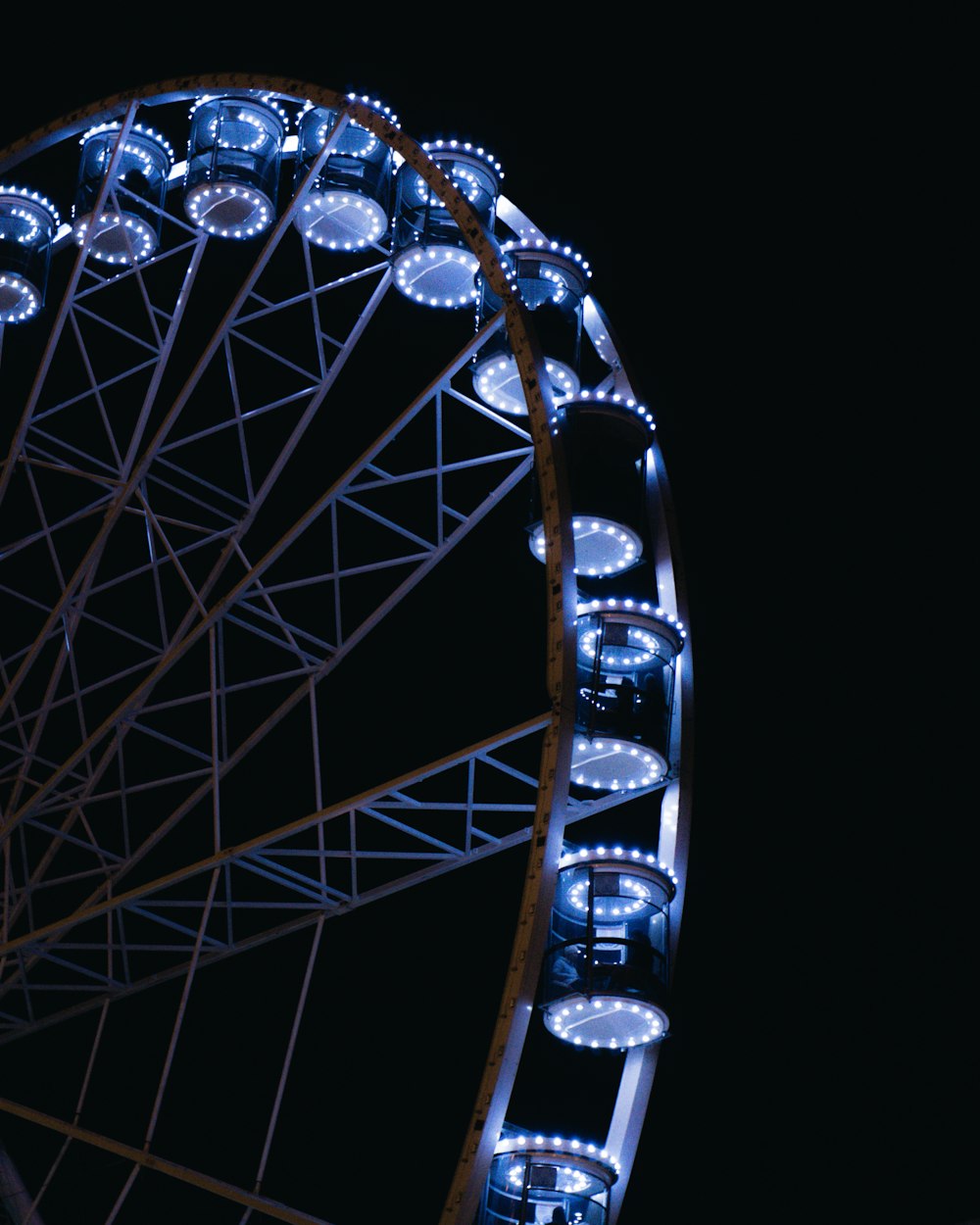 a ferris wheel lit up with blue lights