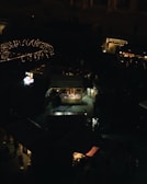 Evening lights twinkling over the bustling market as people browse and connect.