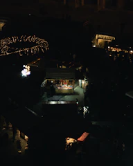 A vibrant marketplace scene showing solar street lights illuminating village roads at dusk.