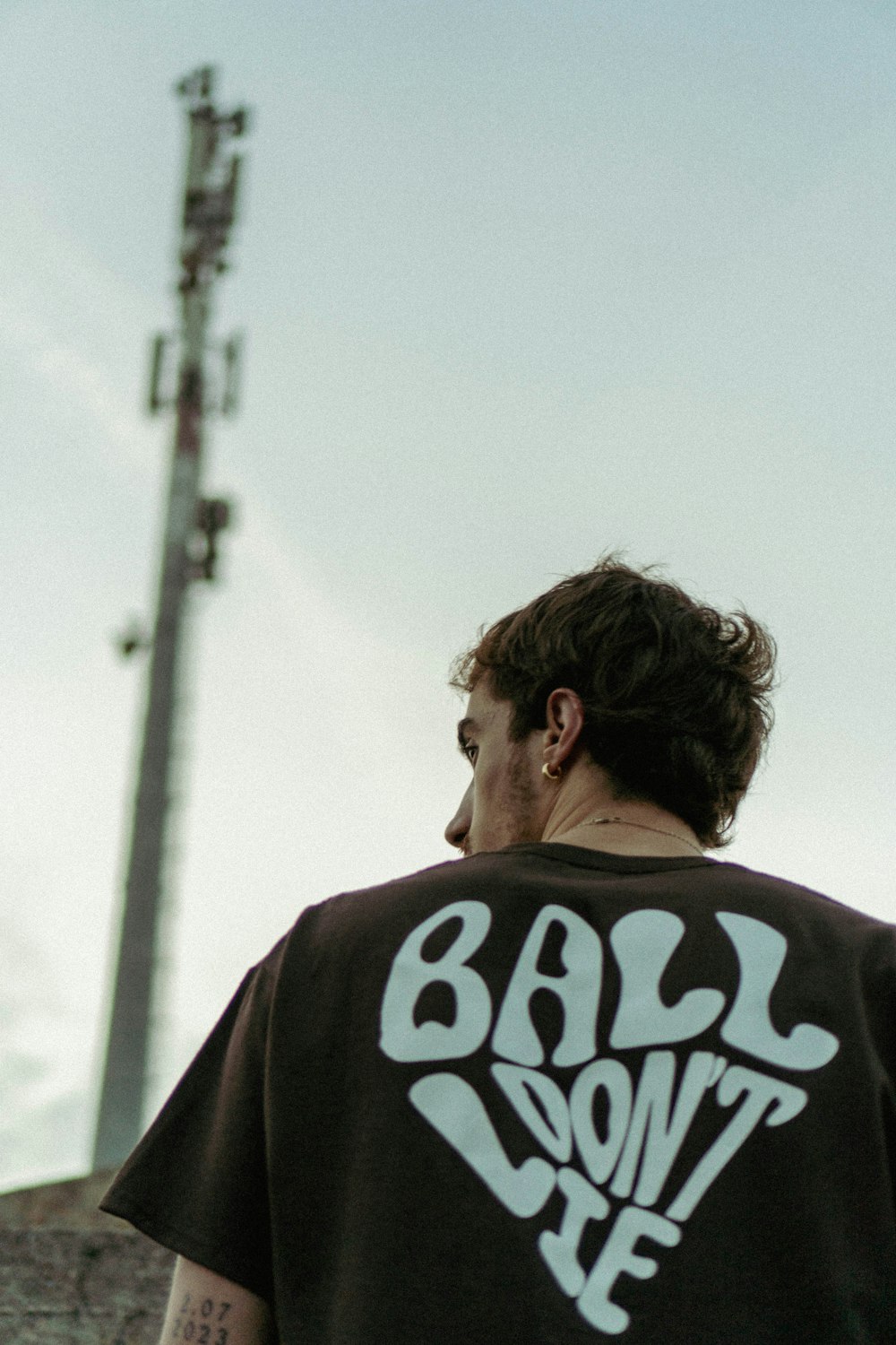 a man standing in front of a cell phone tower