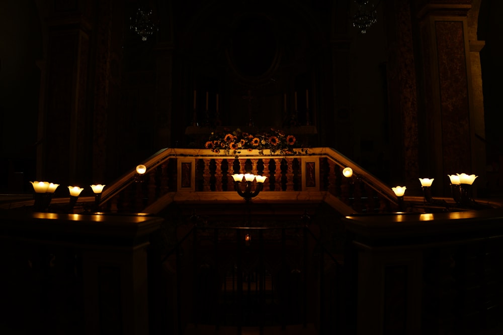 a dark room with candles lit up in the dark