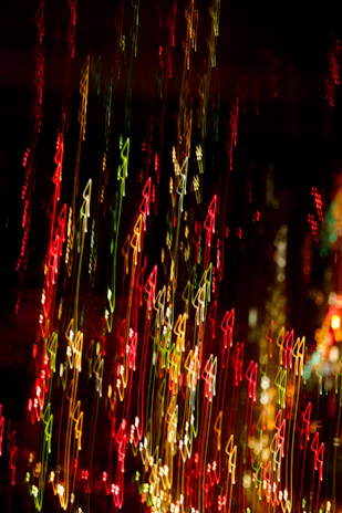 Abstract vector lines in gold, red, and blue swirling dynamically over a dark background with subtle confetti celebrating the trinational spirit.