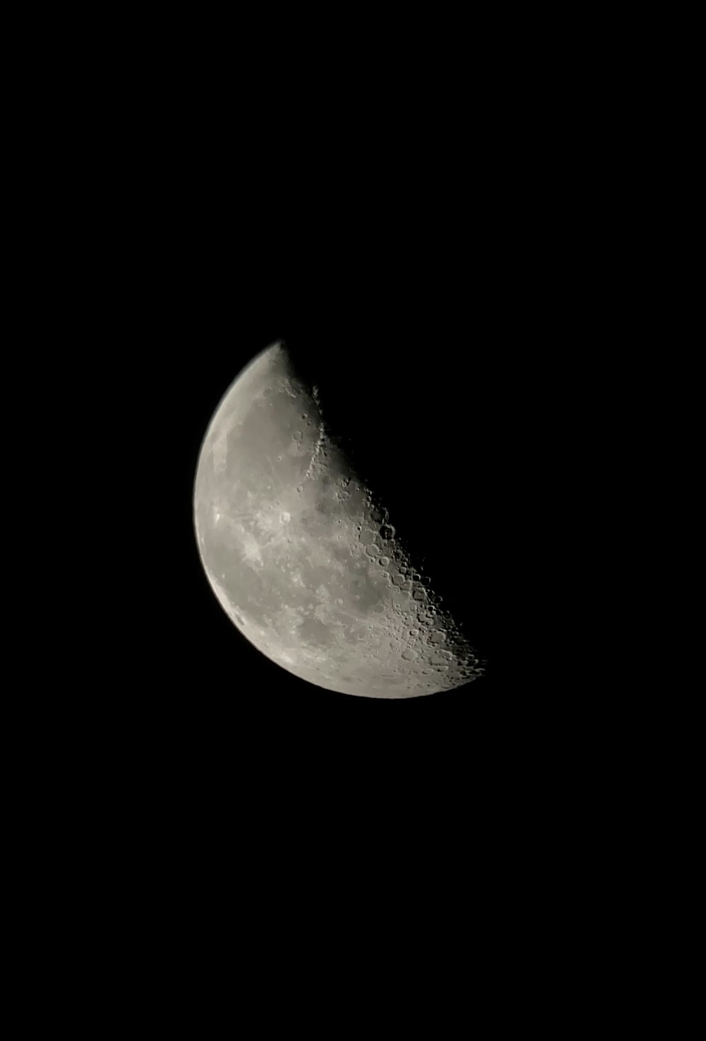 a close up of a half moon in the dark sky