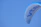 Close-up of a vientoguard cover snugly wrapped around a powered parachute with a blurred background of an airfield.