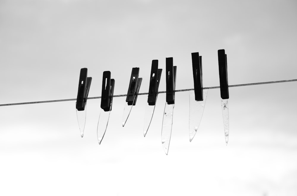 a black and white photo of a line of knives
