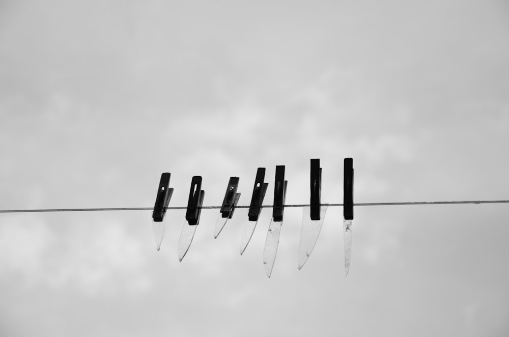a black and white photo of a line of knives
