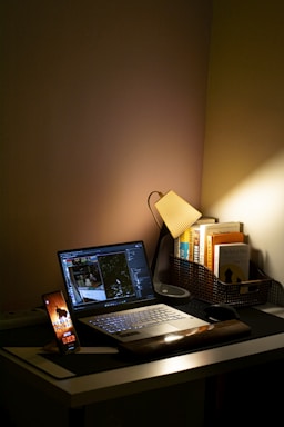 A cozy workspace featuring an open ebook on a sleek laptop with soft lighting.