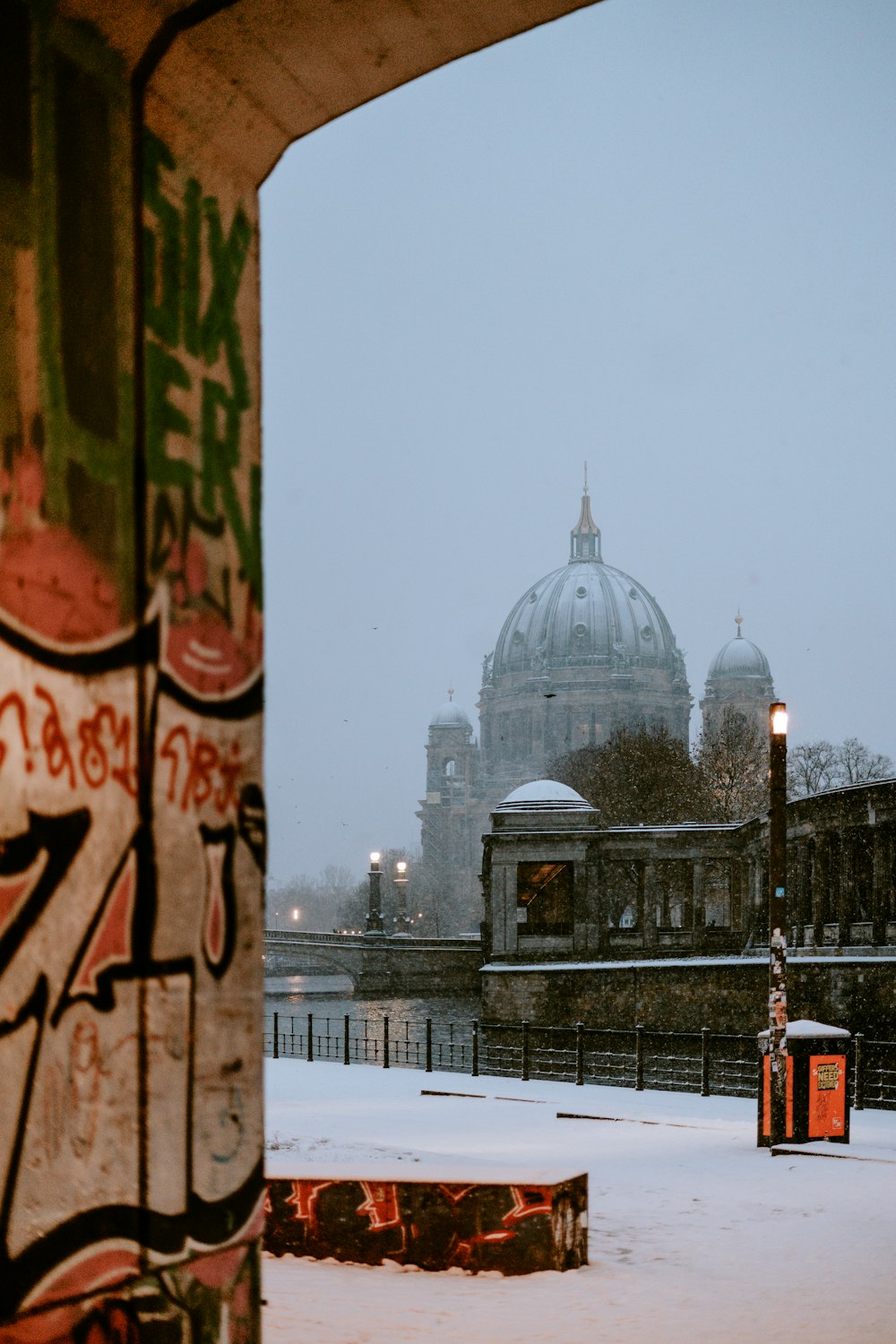 a building with a dome in the background covered in snow