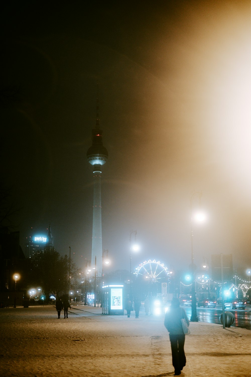 a person walking down a street at night