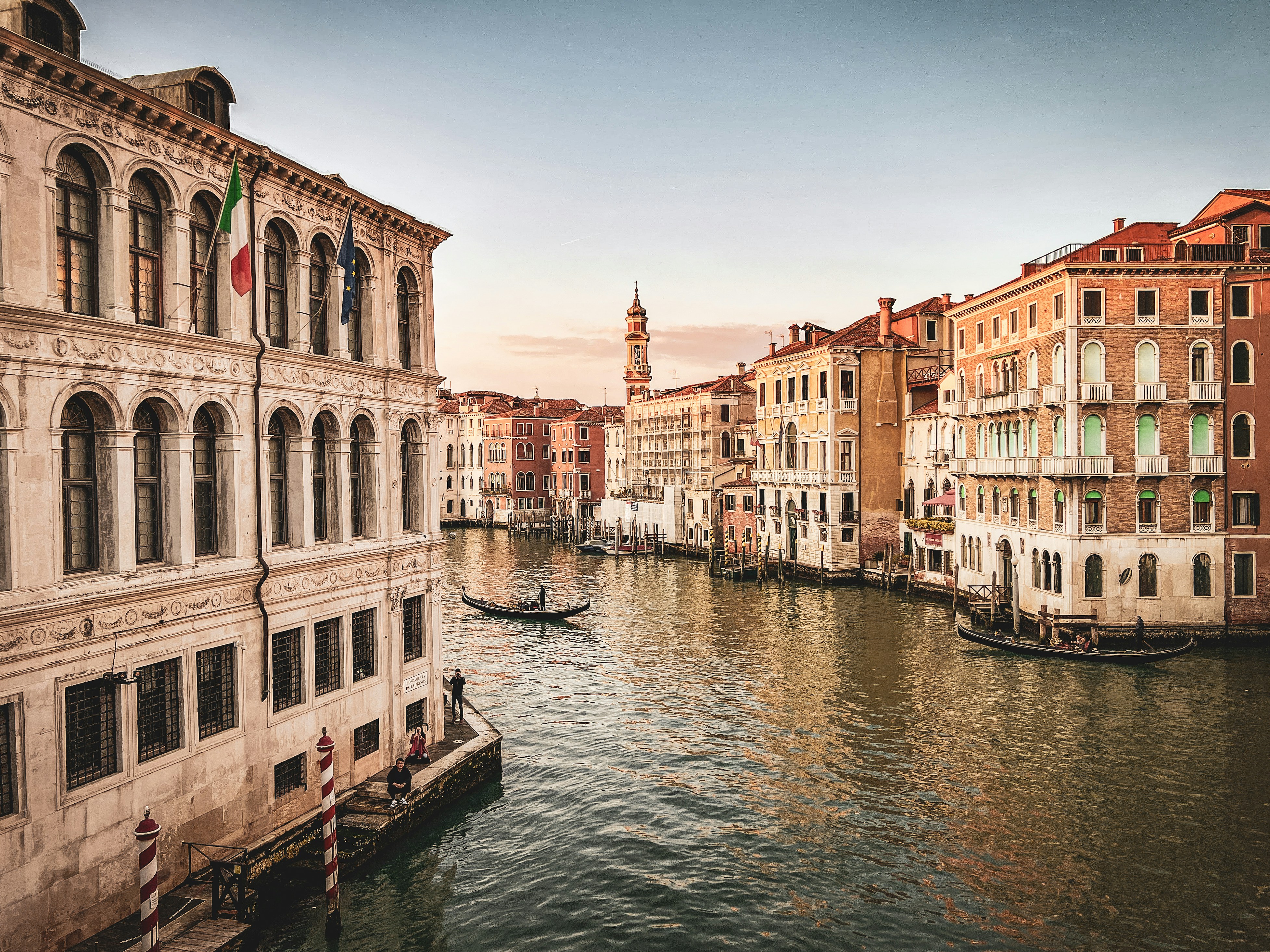 a canal with buildings and a boat in the water