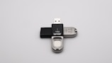 Close-up of a sleek black USB flash drive with the Microdia logo.