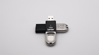 Elegant USB drives customized with corporate branding on a reflective surface.