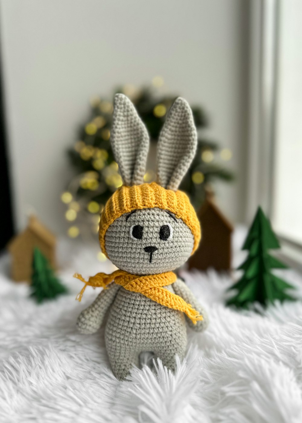 a crocheted bunny with a yellow scarf