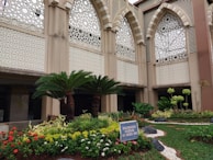 Beautiful garden space outside Karnawati Bhawan with lush greenery and seating