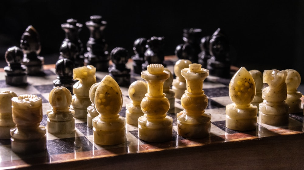 a close up of a chess board with pieces on it