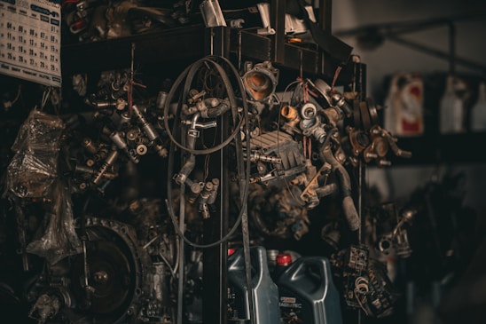 A collection of various car parts displayed on a workshop table.