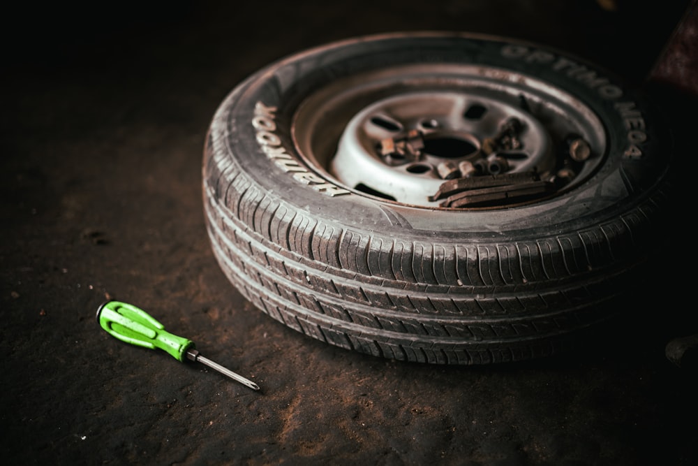 a tire with a wrench next to it