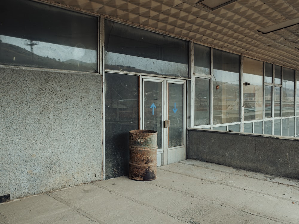 a trash can sitting in front of a building