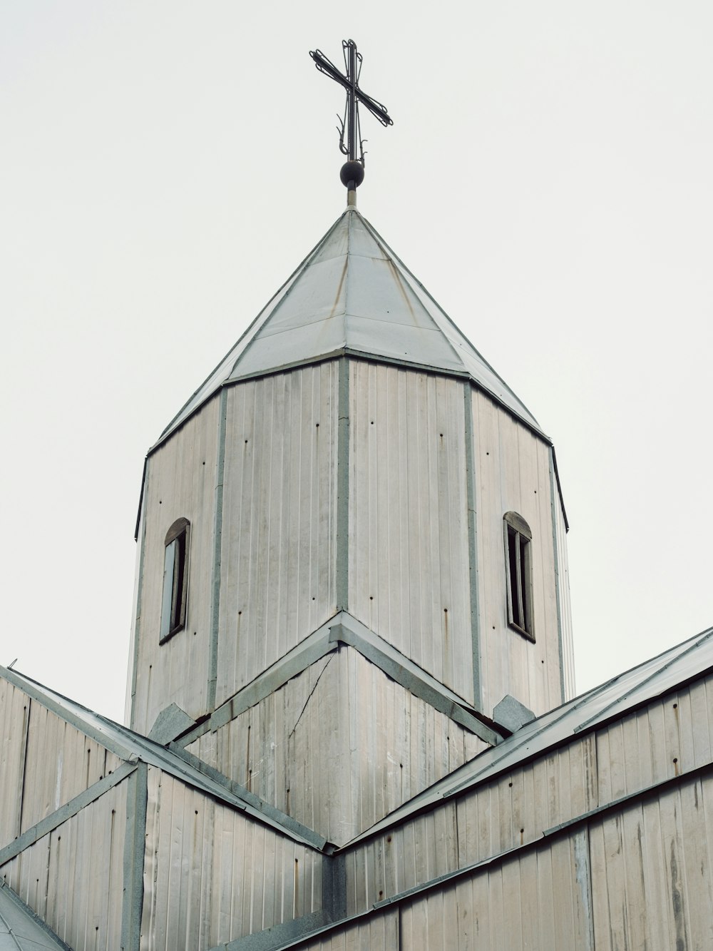 a church steeple with a cross on top of it