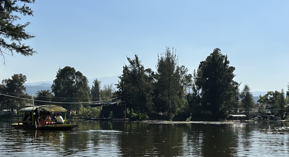 a small boat on a river with trees in the background