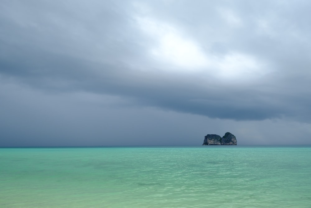 a large body of water under a cloudy sky