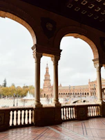 Balcony view overlooking the historic Plaza de Armas with mountains in the background.