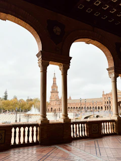 Balcony view overlooking the historic Plaza de Armas with mountains in the background.