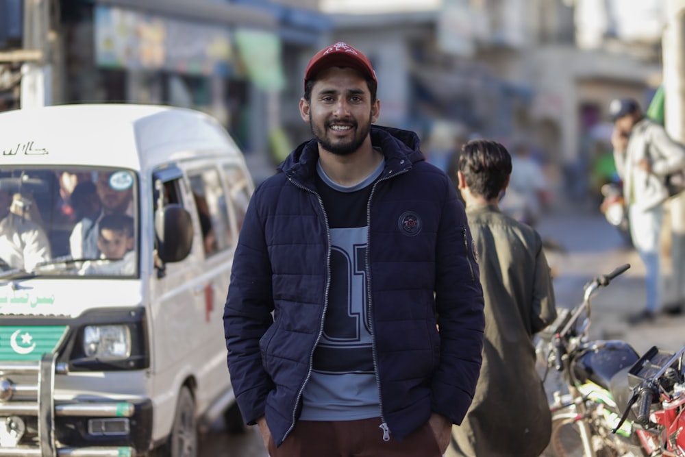 a man standing in the middle of a busy street