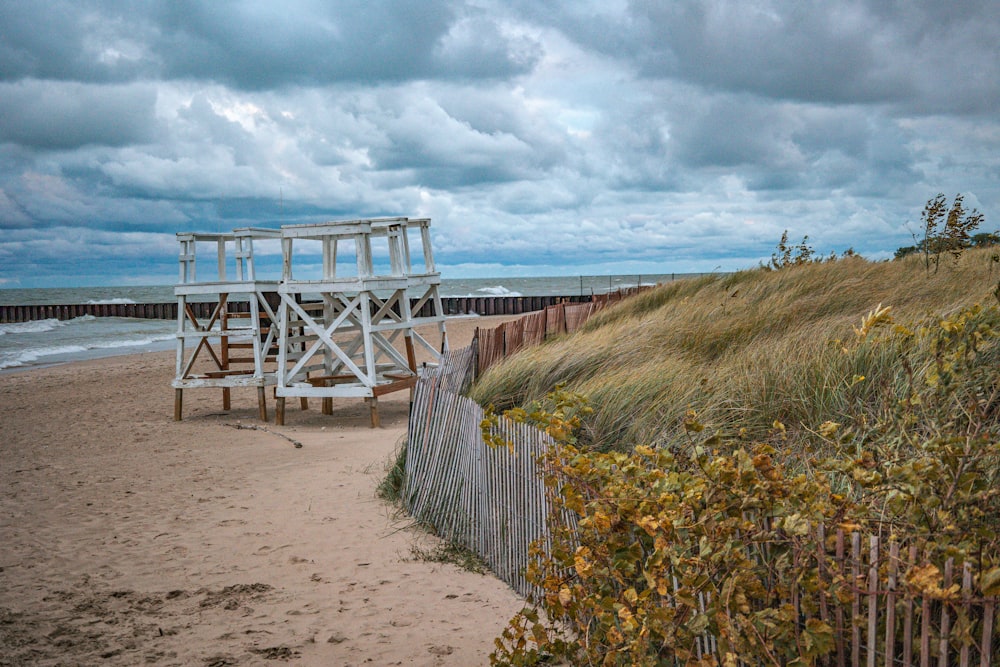 a lifeguard tower on a beach next to the ocean