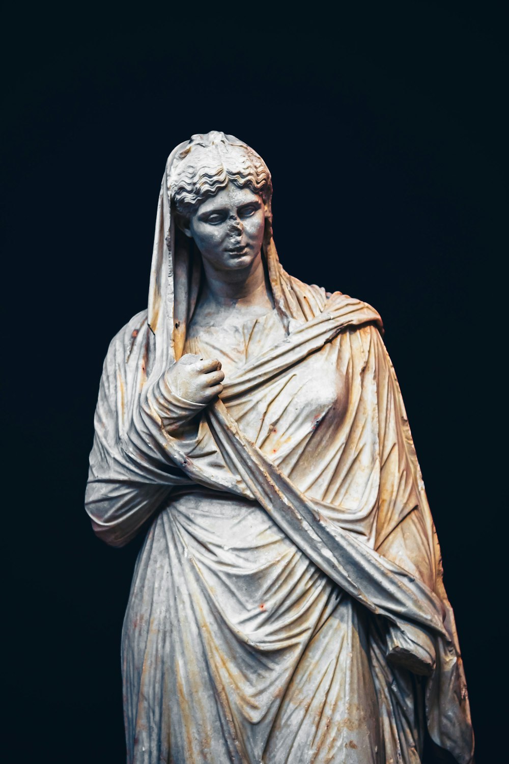 a statue of a woman with a veil on her head