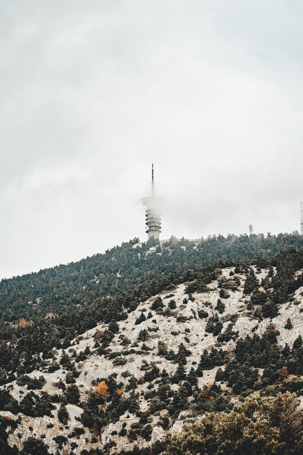 a mountain with a radio tower on top of it