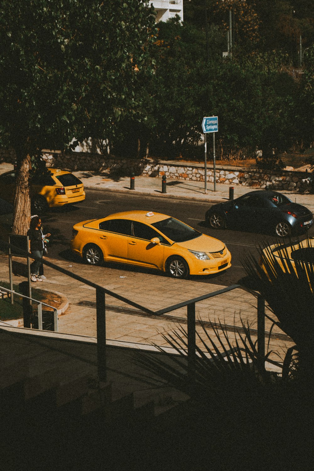 a yellow car is parked in a parking lot