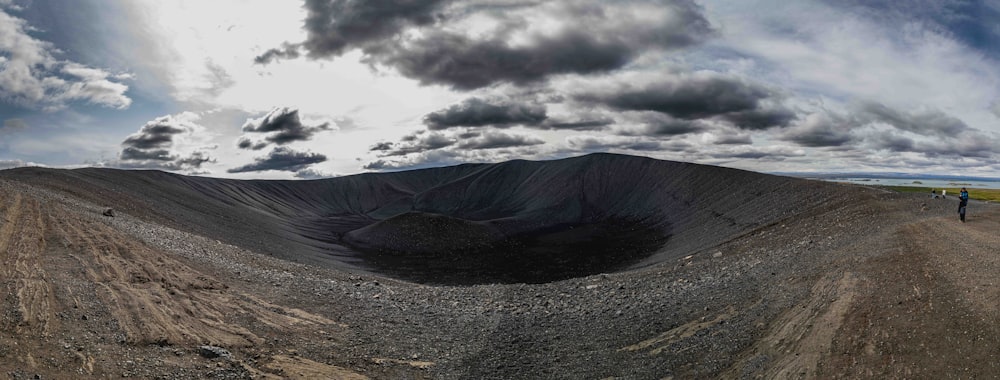 a person standing on top of a dirt hill