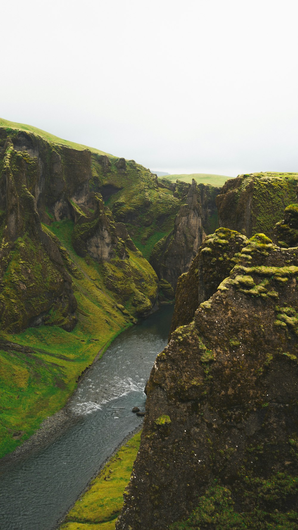 a river running through a lush green valley