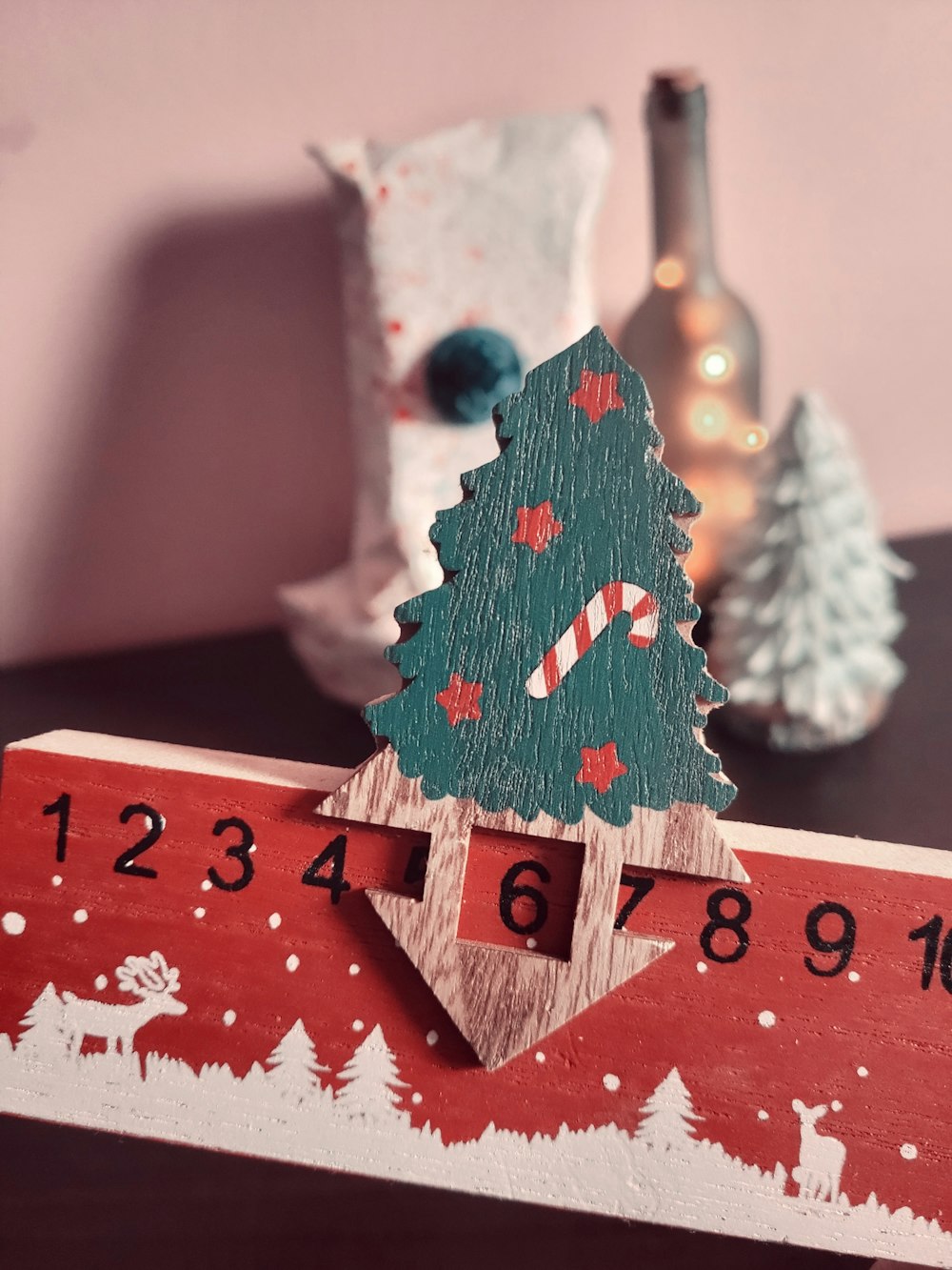 a wooden christmas tree sitting on top of a table