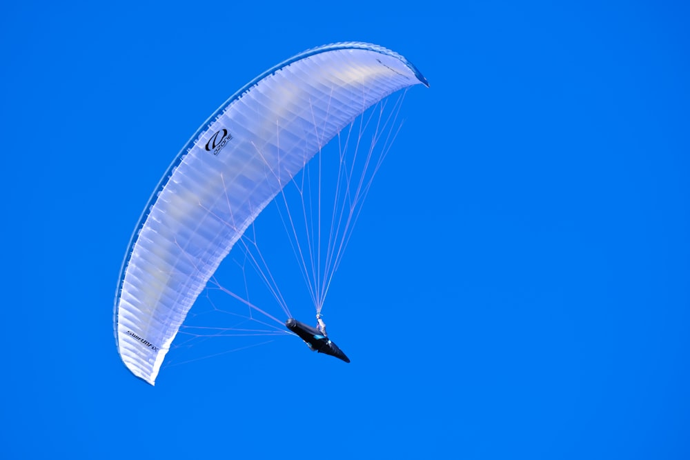 a person is parasailing in the blue sky