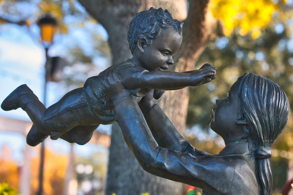 a statue of a boy and a girl holding each other