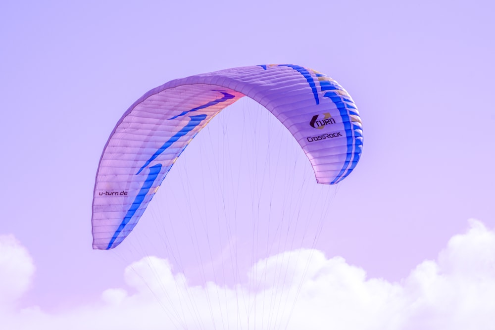 a person is parasailing in the sky on a sunny day