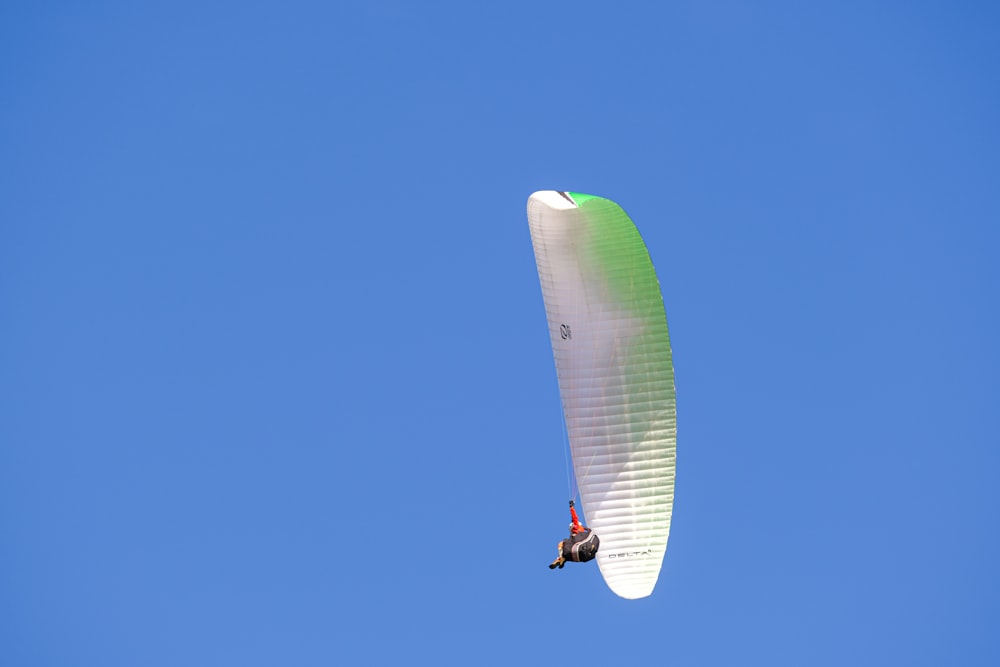 a person is parasailing high in the sky