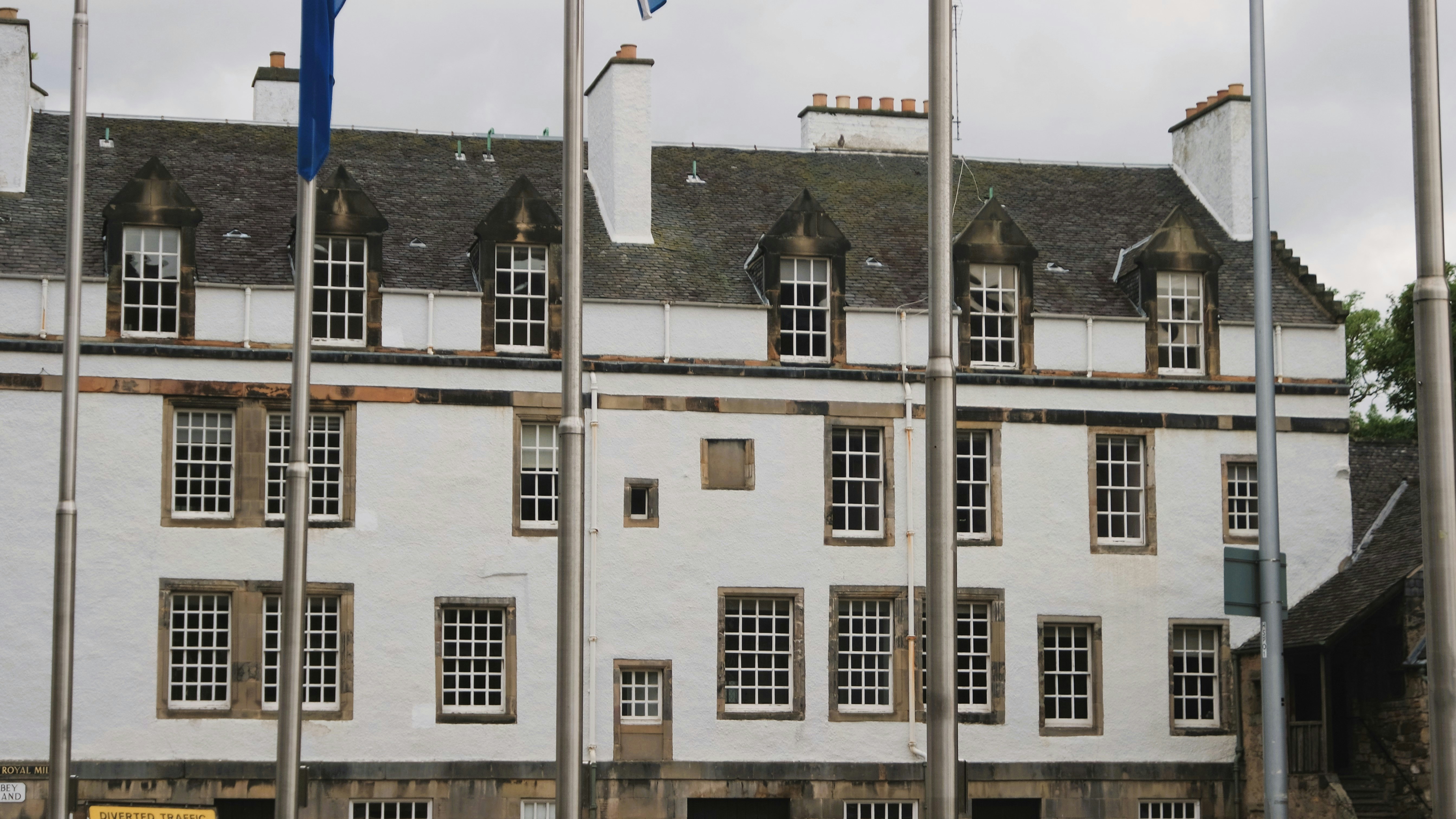 a large white building with flags in front of it