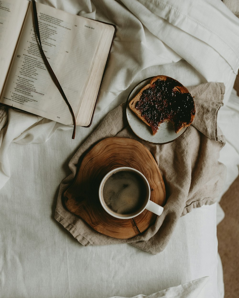 a plate of food and a cup of coffee on a bed