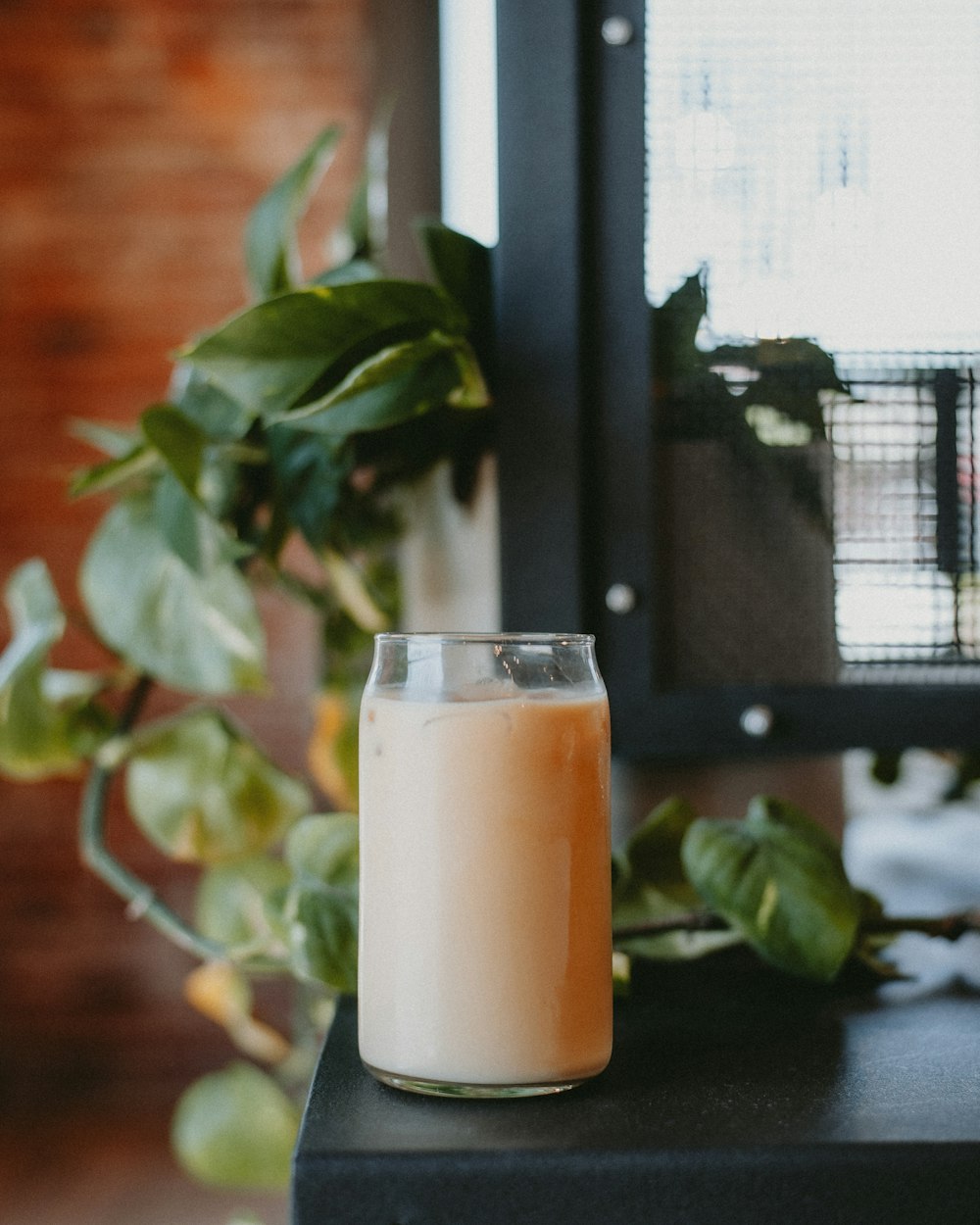 a glass of milk sitting on top of a table